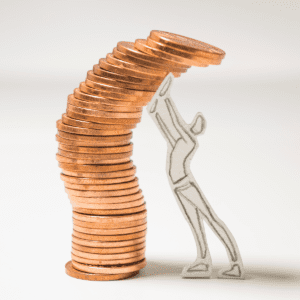 Paper man holds up tumbling stack of pennies